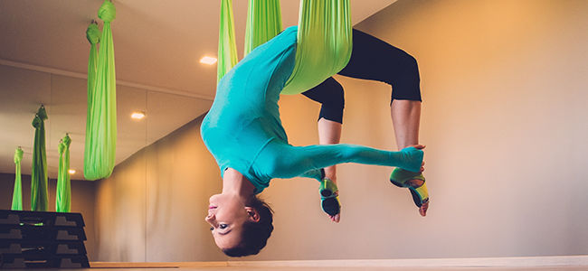 Woman performing aerial yoga position