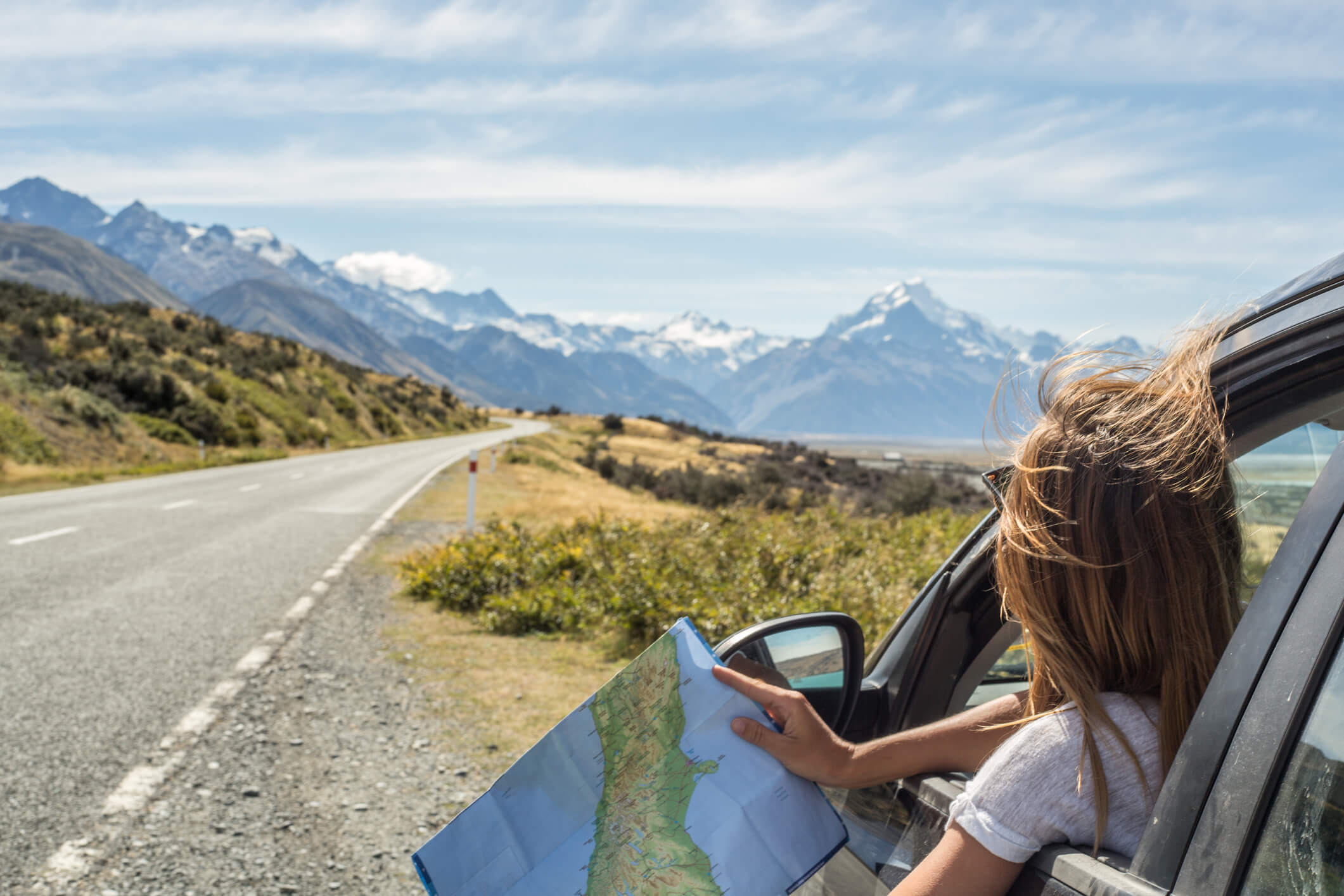 woman in car with map