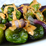 Photo of Roasted Brussels Sprouts and Onions with Sriracha Cream
