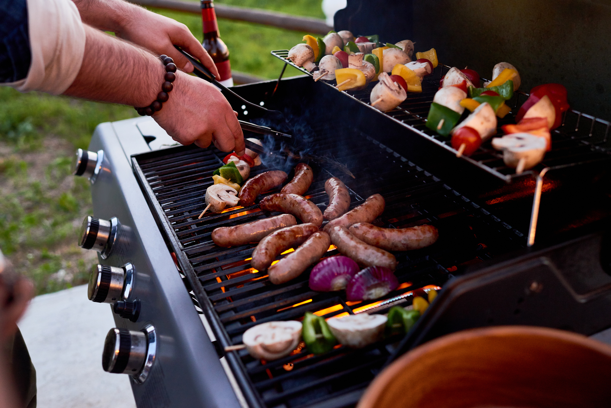 Meats and vegetables cooking on a grill