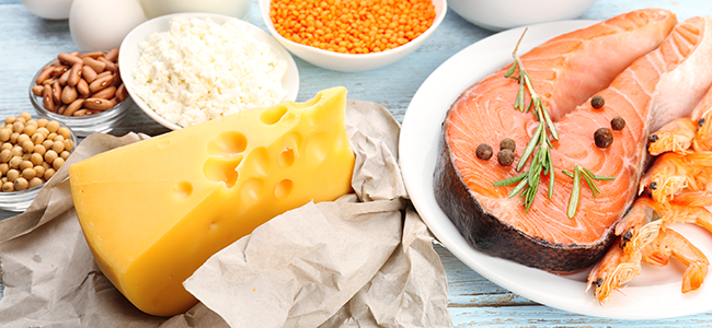 High protein beans, cheese, and fish served in separate dishes on a table